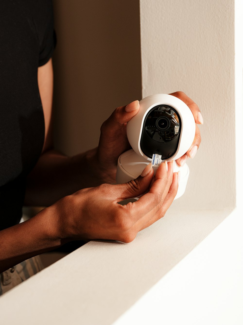 Installer fitting a compact security camera
